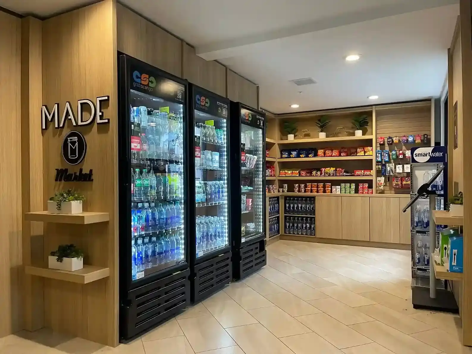 A welcoming hotel market with timber fixtures, coolers and snacks